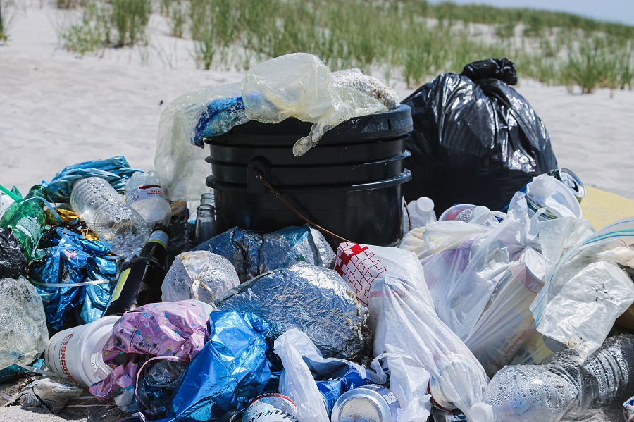 A lot of garbage bags piled on the ground